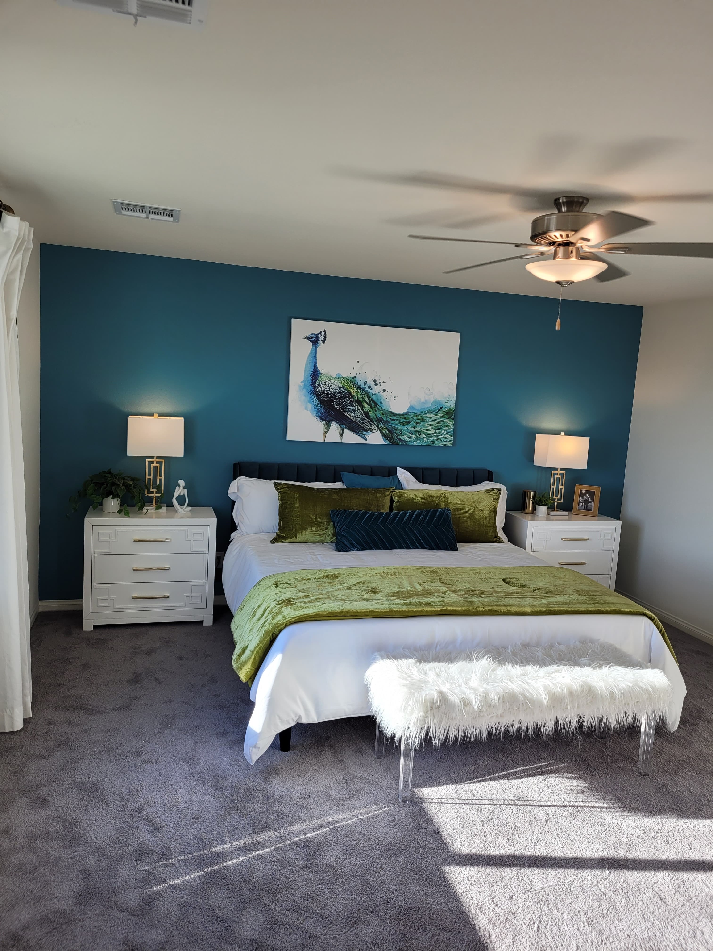 Furnished bedroom featuring the same blue painted accent wall
